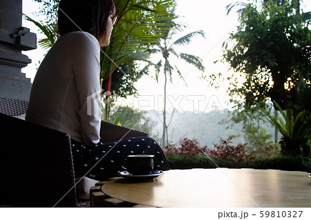 A beautiful young woman drnking tea and relaxing in the morning A beautiful young woman drnking tea and relaxing in the morning 59810327