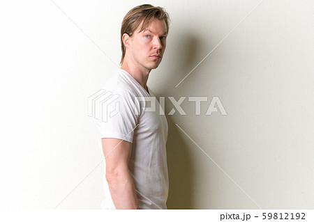 Profile view of young handsome man looking at camera Profile view of young handsome man looking at camera 59812192