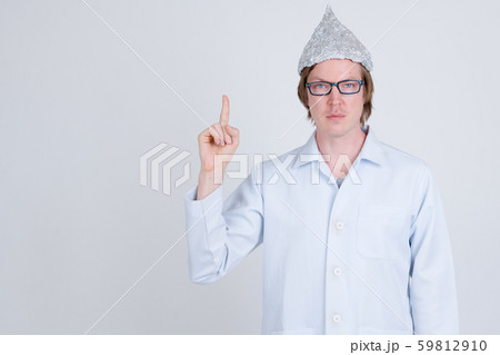 Young man doctor with tinfoil hat pointing up 59812910