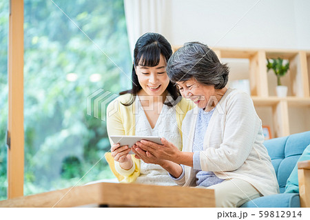タブレット端末を操作する親子 母子 シニア女性 ミドル女性 2人 タブレット端末を操作する親子 母子 シニア女性 ミドル女性 2人 59812914