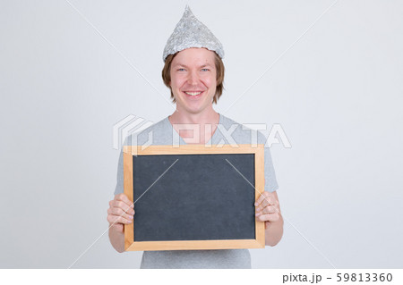 Happy young man with tin foil hat holding blackboard 59813360