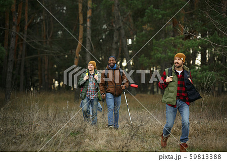 Group of friends on a camping or hiking trip in autumn day Group of friends on a camping or hiking trip in autumn day 59813388
