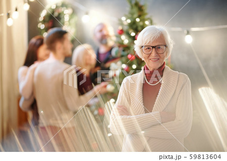 Happy grandma with her arms crossed on chest wishing you merry Christmas Happy grandma with her arms crossed on chest wishing you merry Christmas 59813604