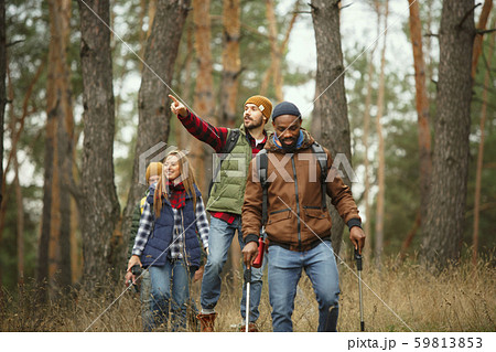 Group of friends on a camping or hiking trip in autumn day Group of friends on a camping or hiking trip in autumn day 59813853