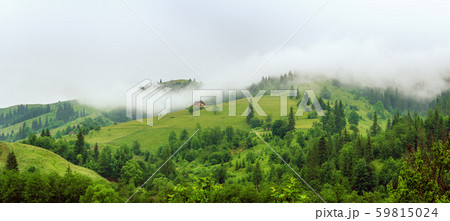 Little house on a green mountain slope 59815024
