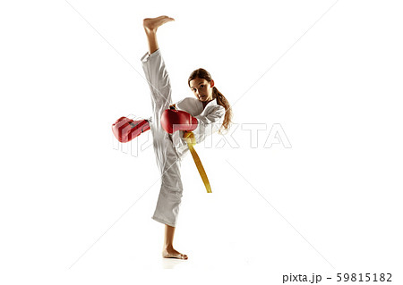 Confident junior in kimono practicing hand-to-hand combat, martial arts 59815182