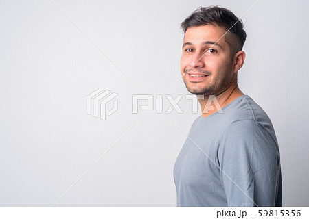 Closeup profile view of happy young Persian man smiling 59815356
