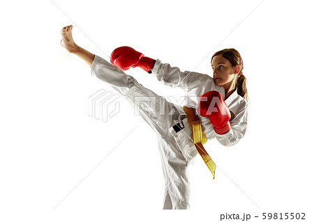 Confident junior in kimono practicing hand-to-hand combat, martial arts Confident junior in kimono practicing hand-to-hand combat, martial arts 59815502