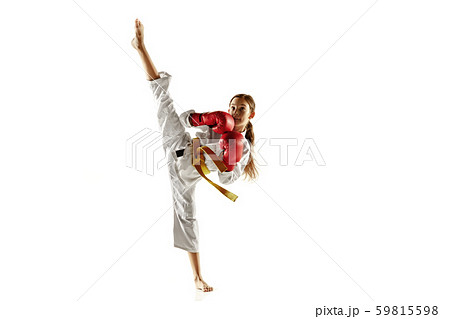 Confident junior in kimono practicing hand-to-hand combat, martial arts Confident junior in kimono practicing hand-to-hand combat, martial arts 59815598