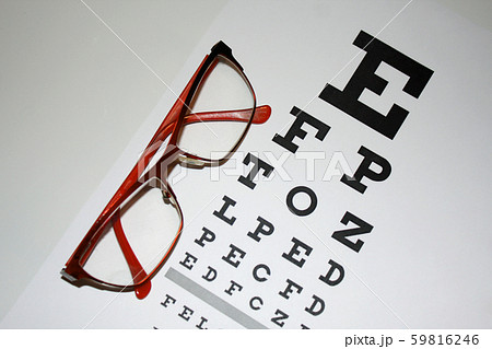 Reading - eyeglasses and eye chart close-up on a Reading - eyeglasses and eye chart close-up on a 59816246