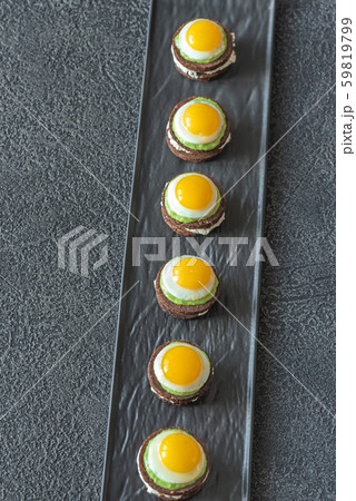 Canape with fried quail eggs Canape with fried quail eggs 59819799
