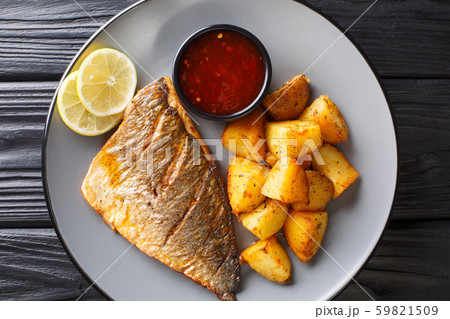 Fried gilt-head fish fillet with a side dish of Fried gilt-head fish fillet with a side dish of 59821509