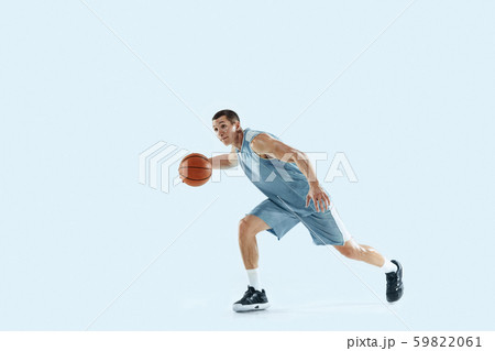 Young caucasian basketball player against white studio background Young caucasian basketball player against white studio background 59822061