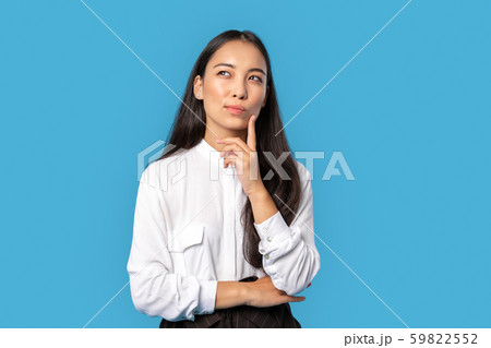 Freestyle. Young woman wearing shirt and skirt standing isolated on blue touching face thinking of Freestyle. Young woman wearing shirt and skirt standing isolated on blue touching face thinking of 59822552