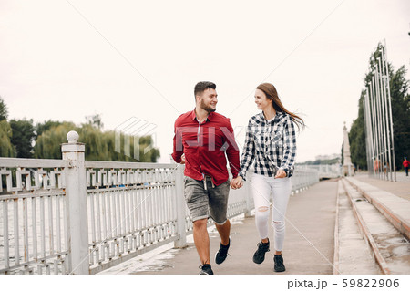 Beautiful couple spend time in a summer park Beautiful couple spend time in a summer park 59822906