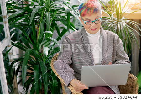 Busy senior woman with laptop while working 59824644