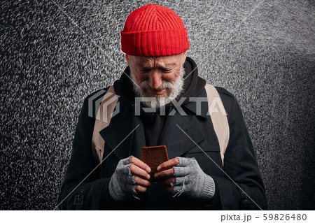Criyng desperate man with piece of bread 59826480