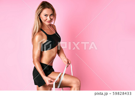 Pretty woman with measure tape 59828433