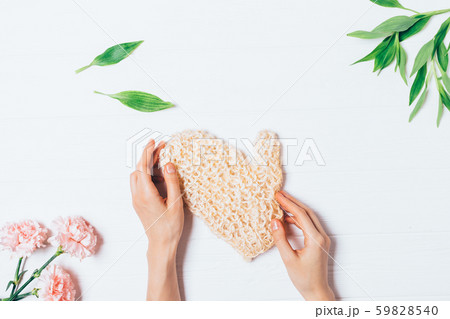 Female hands holding massage body washcloth 59828540