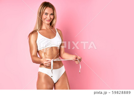Young lady with measuring tape in hands Young lady with measuring tape in hands 59828889