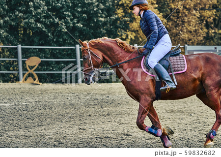 Young woman jockey in white black dress and black 59832682