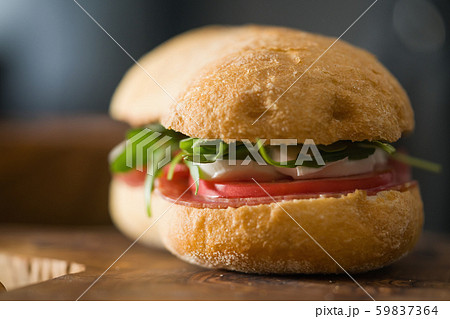 ciabatta sandwich with salami and mozzarella cheese on olive board ciabatta sandwich with salami and mozzarella cheese on olive board 59837364