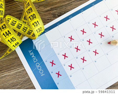 Diet plan concept. Measuring tape and diet plan on wooden background. Diet plan concept. Measuring tape and diet plan on wooden background. 59841311