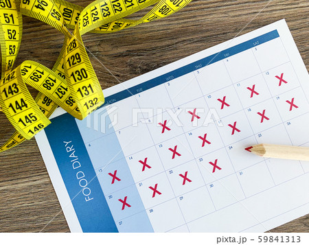 Diet plan concept. Measuring tape and diet plan on wooden background. Diet plan concept. Measuring tape and diet plan on wooden background. 59841313