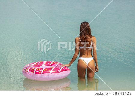 Woman in the Water with a Rubber Ring. 59841425