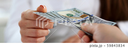 Male arm pay bunch of hundred dollars bills Male arm pay bunch of hundred dollars bills 59843834