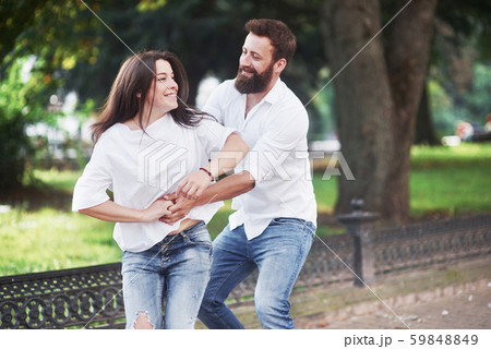 Romantic couple enyojing in moments of happiness in the park. Lifestyle concept love and tenderness Romantic couple enyojing in moments of happiness in the park. Lifestyle concept love and tenderness 59848849