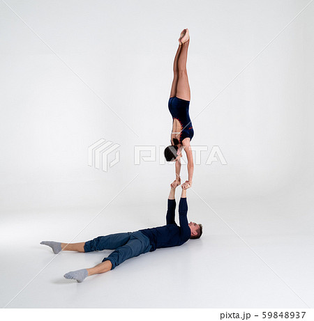 Duo Of Acrobats Showing hand to hand Trick, Isolated On White Duo Of Acrobats Showing hand to hand Trick, Isolated On White 59848937