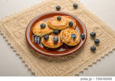 Homemade cheesecakes on a plate with berries and syrup close-up. Healthy food 59848966