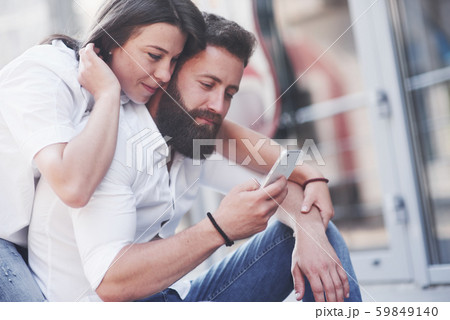 Beautiful happy couple hugging on the city street.Lifestyle concept love and romance Beautiful happy couple hugging on the city street.Lifestyle concept love and romance 59849140