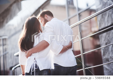 Beautiful happy couple hugging on the city street.Lifestyle concept love and romance Beautiful happy couple hugging on the city street.Lifestyle concept love and romance 59849388