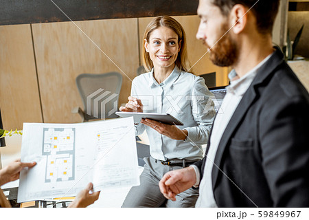 Colleagues working on architectural project in the office Colleagues working on architectural project in the office 59849967