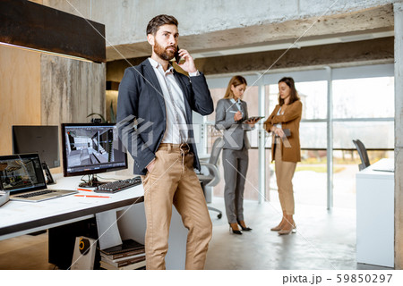 Businessman with colleagues at the office Businessman with colleagues at the office 59850297