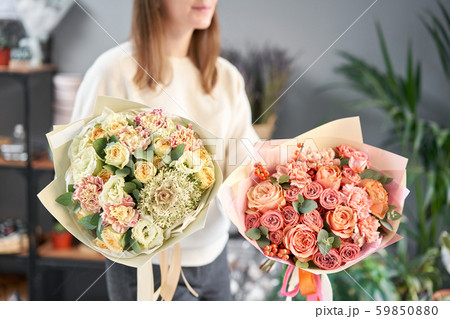 European floral shop. Two Beautiful bouquets of mixed flowers in womans hands. the work of the European floral shop. Two Beautiful bouquets of mixed flowers in womans hands. the work of the 59850880