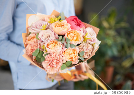 European floral shop. Beautiful bouquet of mixed flowers in womans hands. the work of the florist at European floral shop. Beautiful bouquet of mixed flowers in womans hands. the work of the florist at 59850989