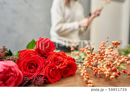 Step by step florist woman creates red beautiful bouquet of mixed flowers. Handsome fresh bunch Step by step florist woman creates red beautiful bouquet of mixed flowers. Handsome fresh bunch 59851739