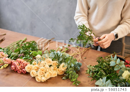 Step by step florist woman creates red beautiful bouquet of mixed flowers. Handsome fresh bunch 59851743