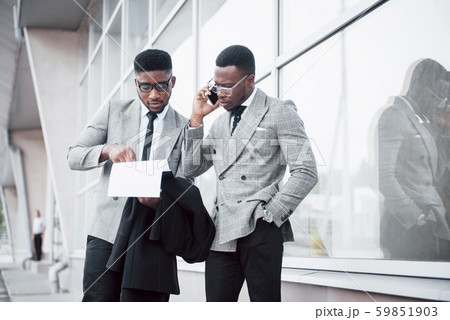 Business communication. Two cheerful business men talking to each other and discussing a project 59851903