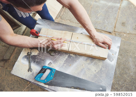 A man works in a joiner's shop, working with a tree. A man works in a joiner's shop, working with a tree. 59852015