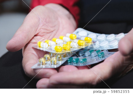 Closeup of a tablet on the hands of an old woman. The concept of choosing medication in old age 59852355