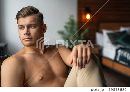 Handsome guy is relaxing in his bedroom 59853682
