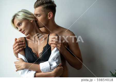 Young man holding woman by the shoulders Young man holding woman by the shoulders 59854018