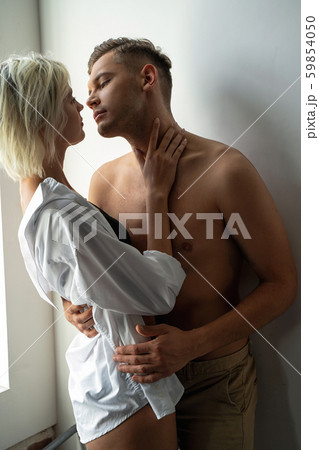 Pretty woman in man shirt near boyfriend Pretty woman in man shirt near boyfriend 59854050