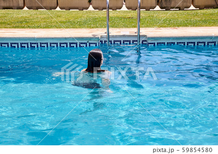 woman swimming in a pool 59854580
