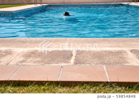 woman swimming in a pool woman swimming in a pool 59854849