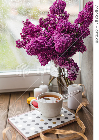 Romantic background with cup of tea, lilac flowers and macaroons. Card for Mothers, Womans Day Romantic background with cup of tea, lilac flowers and macaroons. Card for Mothers, Womans Day 59856867